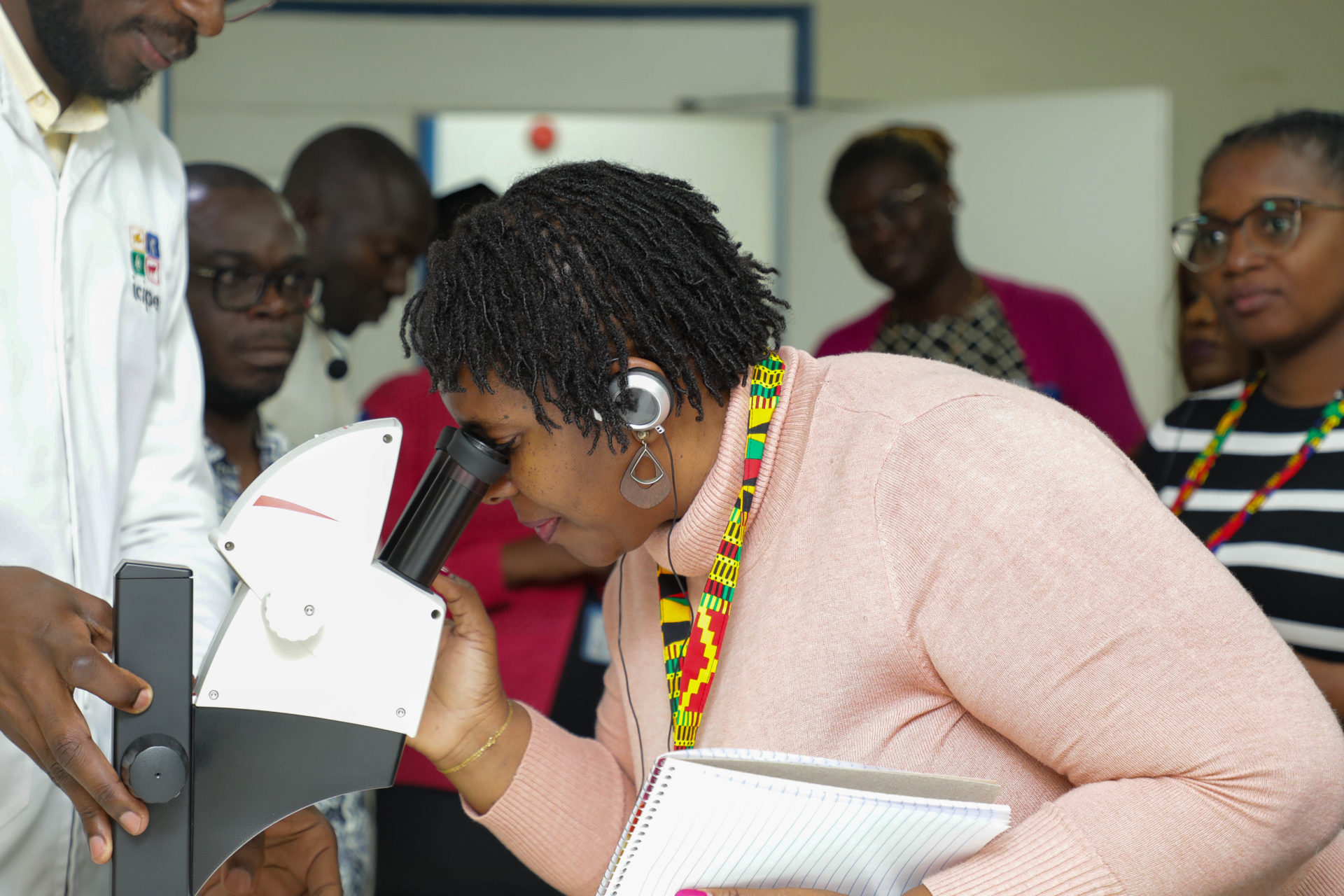 Prof Lubacha Zilhao, Director of the Office of Evaluation and Quality at the University Púnguè (UNIPUNGUE) and coordinator of the MozSkills project looks through a microscope at the Arthropod Pathology Unit